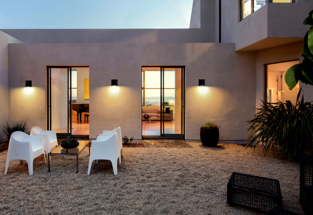 Modern Mediterranean home exterior at twilight. | แสงทองอินเตอร์เทรด